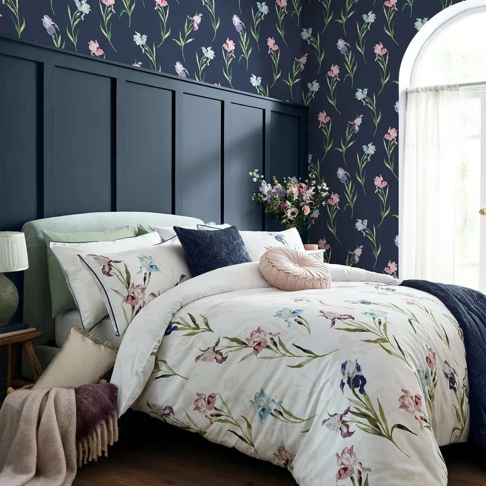 Hawling Irises Midnight Seaspray wallpaper, a watercolour iris trail on a deep ground, in a lamp-lit room